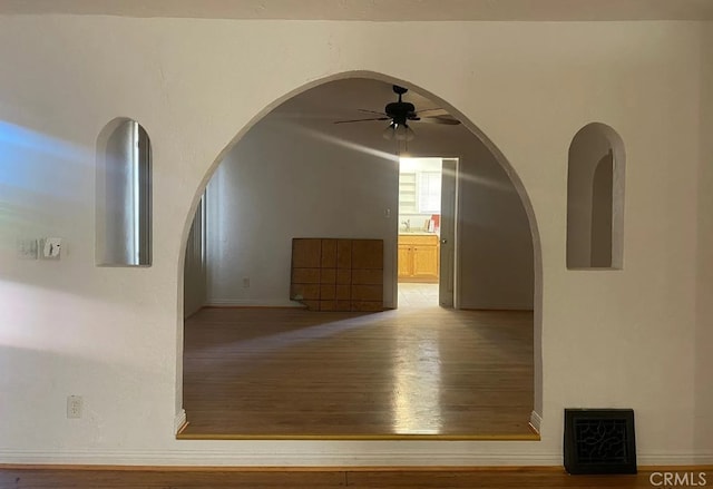 1816 W 76th St, Los Angeles, CA 90047 - corridor with light wood-style floors and arched walkways