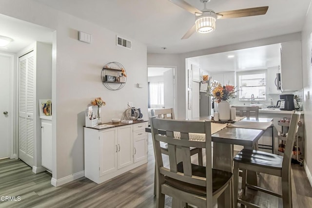 dining area with hardwood / wood-style flooring and ceiling fan