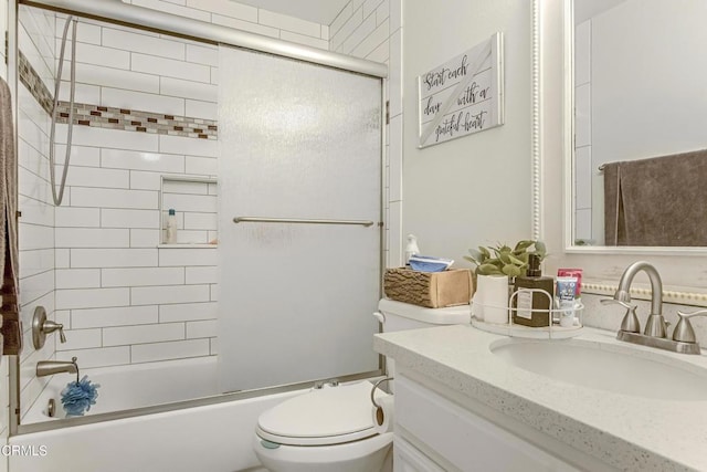 full bathroom featuring vanity, toilet, and bath / shower combo with glass door