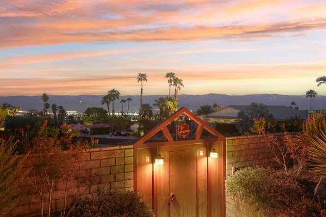 outdoor structure at dusk featuring a mountain view