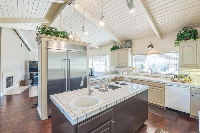 kitchen with tile countertops, dark hardwood / wood-style floors, white appliances, and sink