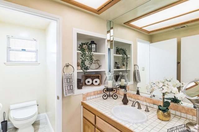 bathroom with vanity and toilet