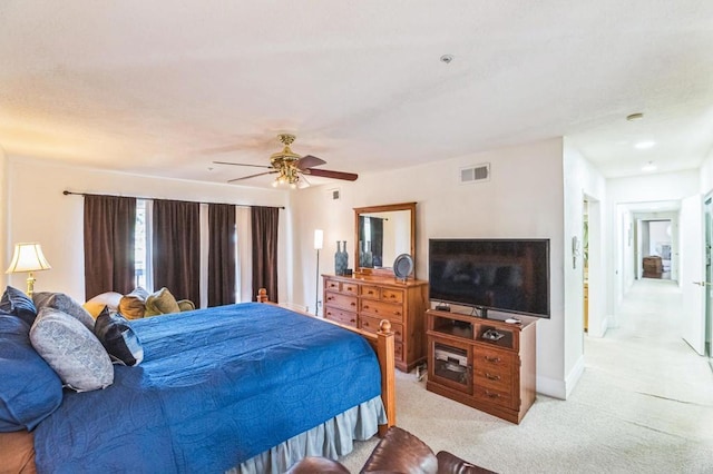 bedroom featuring ceiling fan and light carpet