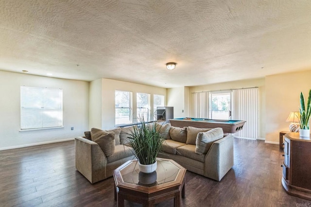 living room featuring dark hardwood / wood-style flooring, a textured ceiling, and pool table