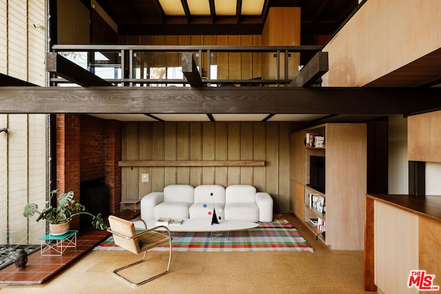 interior space featuring wood walls and beam ceiling