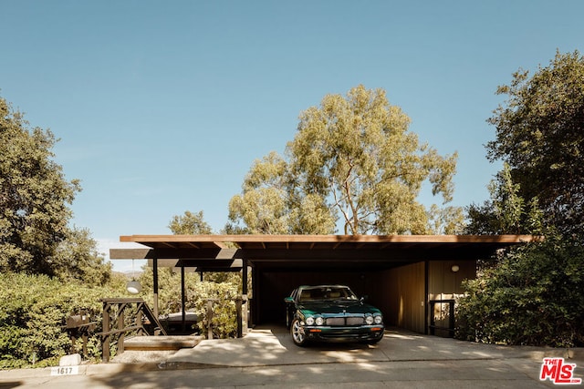 view of vehicle parking with a carport