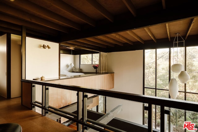 basement with wood ceiling and a wealth of natural light