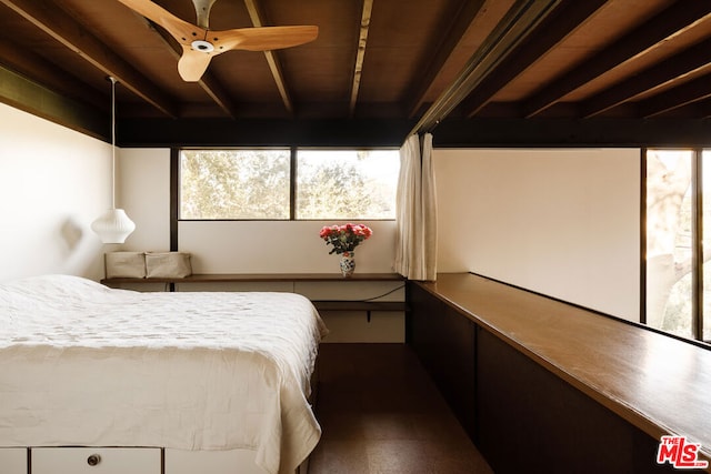 bedroom featuring beamed ceiling, ceiling fan, and hardwood / wood-style flooring