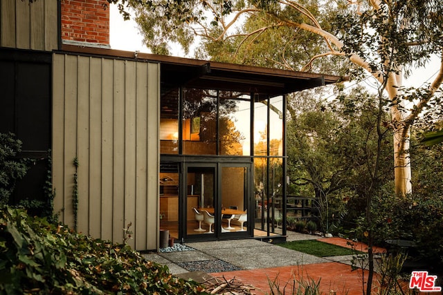 view of outbuilding featuring a sunroom