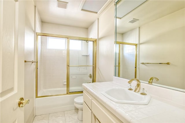 full bathroom featuring toilet, combined bath / shower with glass door, and vanity