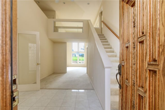 interior space featuring light tile patterned flooring and a high ceiling