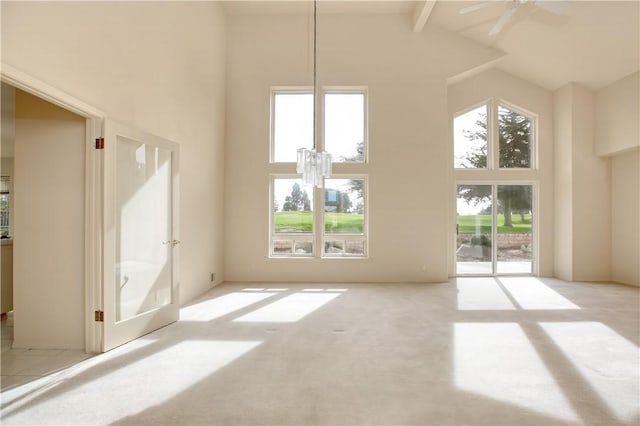 unfurnished living room with ceiling fan with notable chandelier, beam ceiling, light carpet, and high vaulted ceiling