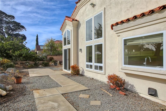 view of side of home featuring a patio area