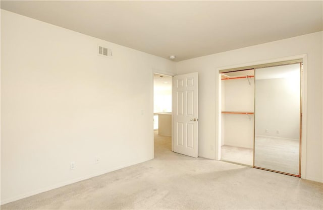 unfurnished bedroom with carpet and a closet