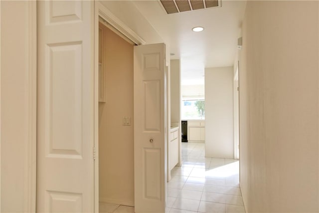 corridor featuring light tile patterned floors