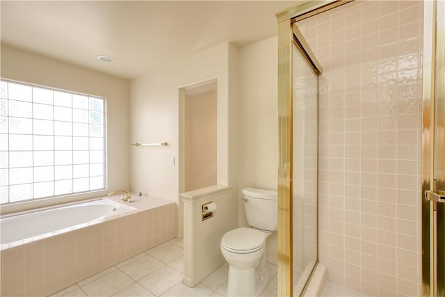 bathroom with tile patterned floors, shower with separate bathtub, and toilet