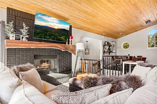 living room featuring a fireplace, wood ceiling, and lofted ceiling