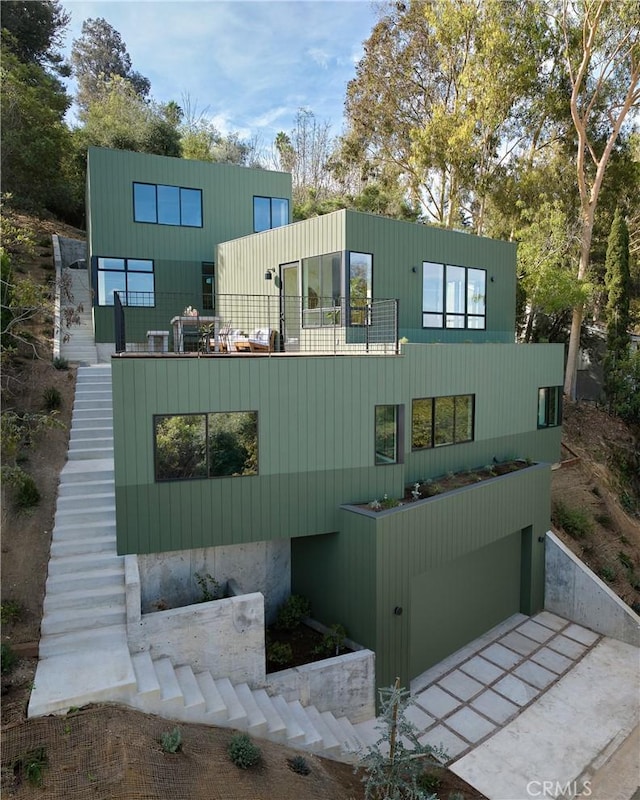 rear view of property featuring a garage