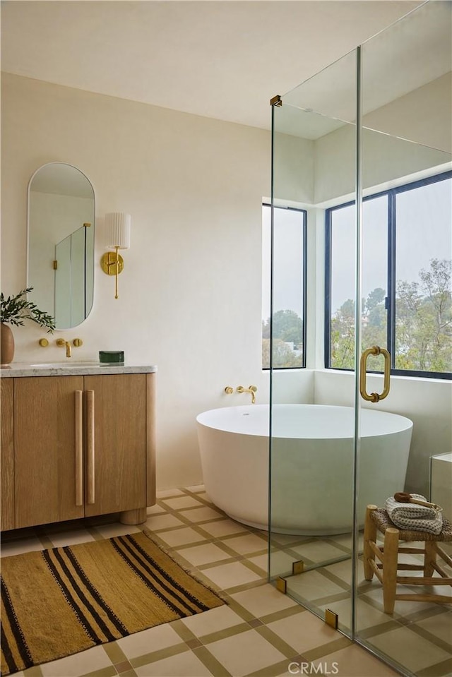 bathroom featuring vanity and a bath