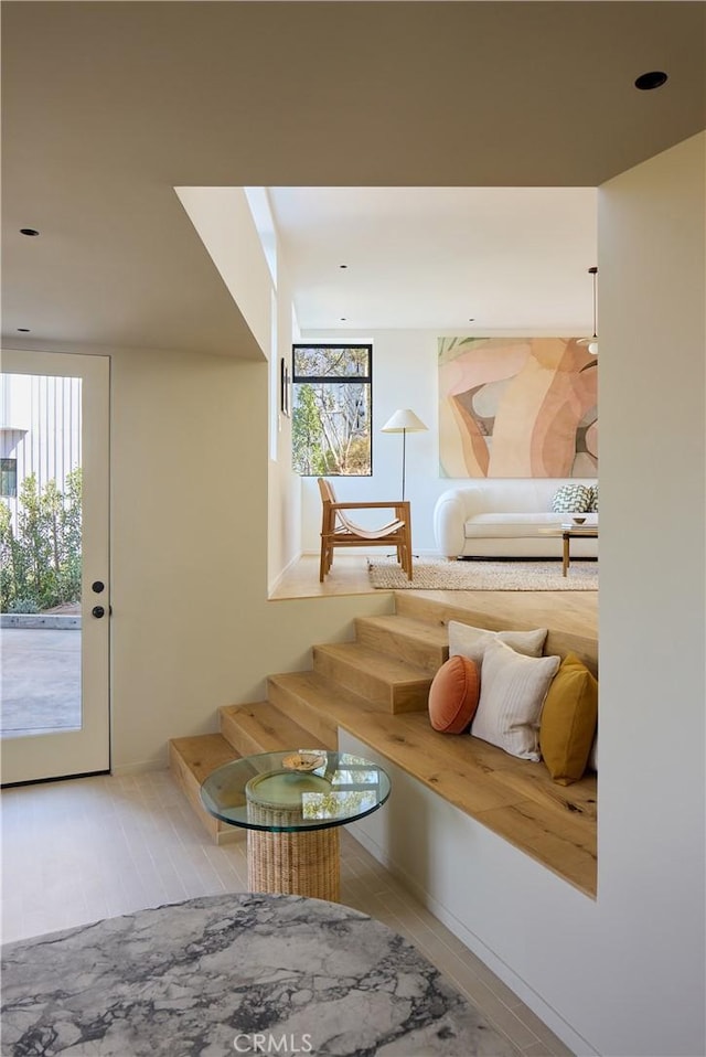 living area with a healthy amount of sunlight and light hardwood / wood-style floors