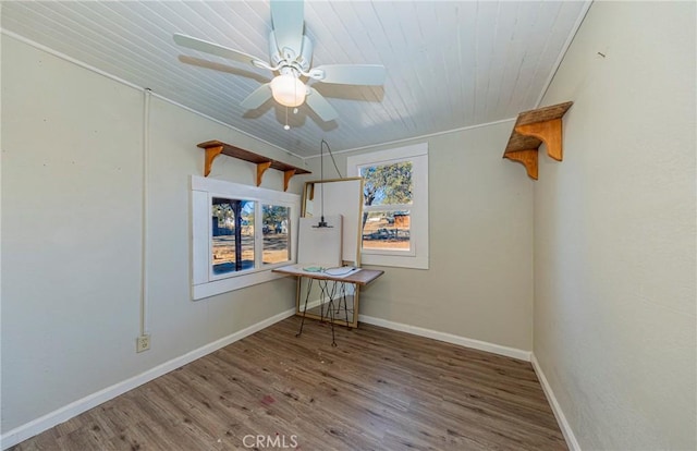 empty room with ceiling fan, hardwood / wood-style floors, wood ceiling, and ornamental molding