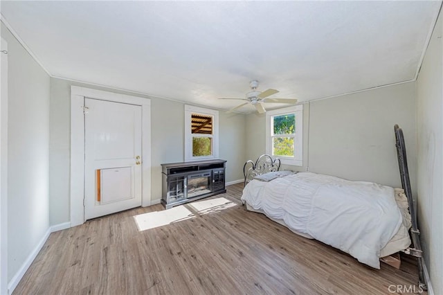 bedroom with light hardwood / wood-style flooring and ceiling fan