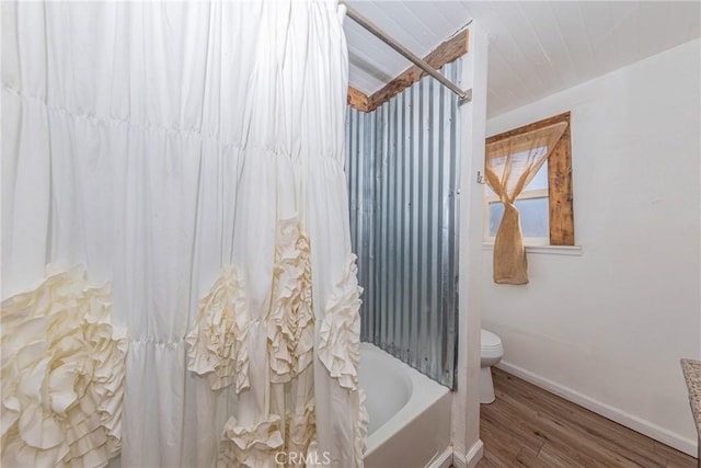 bathroom featuring wood-type flooring, toilet, and shower / bath combo