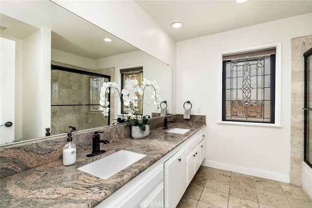 full bath featuring recessed lighting, a sink, a tile shower, and baseboards