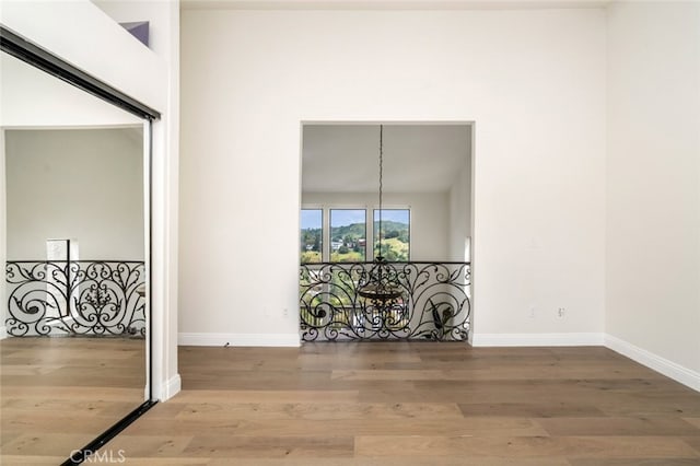 empty room featuring wood finished floors and baseboards