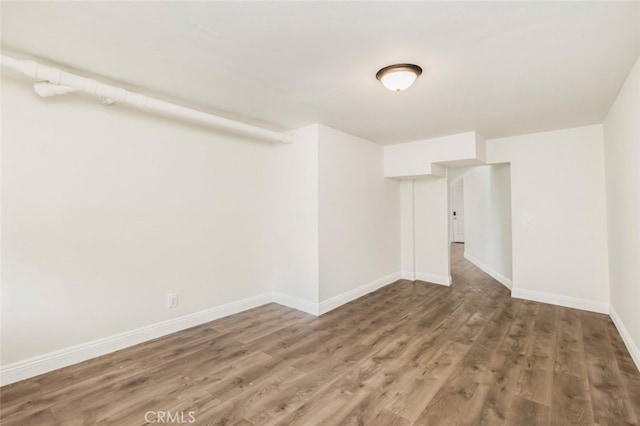 unfurnished room featuring wood finished floors and baseboards