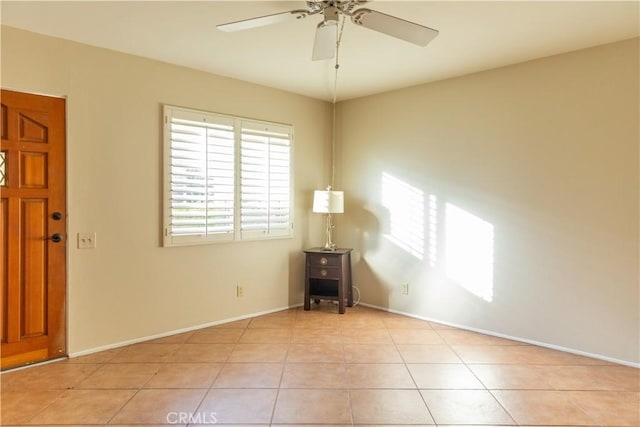 tiled foyer entrance featuring ceiling fan