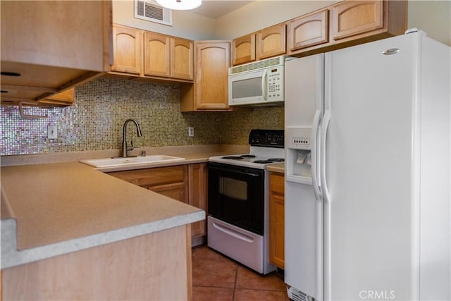 kitchen featuring light brown cabinets, white appliances, sink, light tile patterned floors, and tasteful backsplash