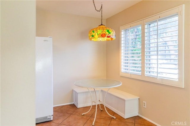 unfurnished dining area featuring tile patterned flooring