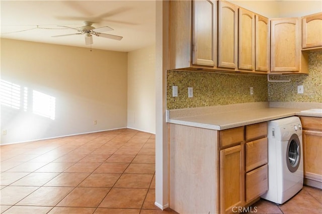 kitchen featuring ceiling fan, washer / clothes dryer, decorative backsplash, light brown cabinetry, and light tile patterned floors