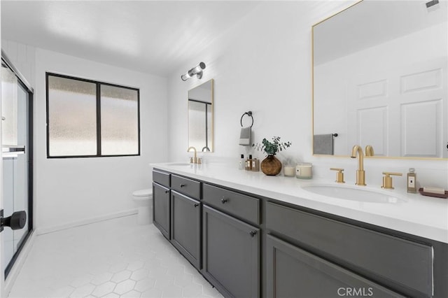 bathroom with tile patterned flooring, vanity, and toilet