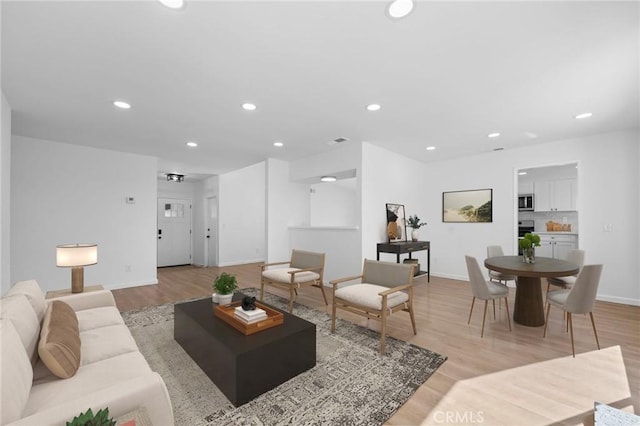 living room with light hardwood / wood-style flooring