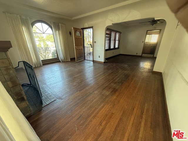 interior space with ceiling fan and dark hardwood / wood-style floors