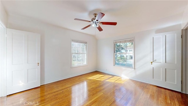 empty room with ceiling fan and hardwood / wood-style floors