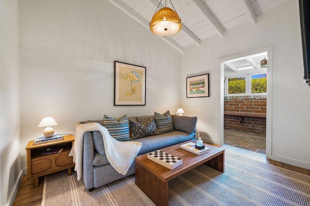 living room featuring lofted ceiling with beams and wood-type flooring