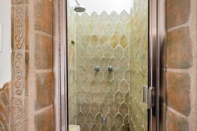 bathroom featuring a shower with door