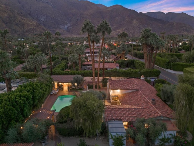 aerial view at dusk featuring a mountain view