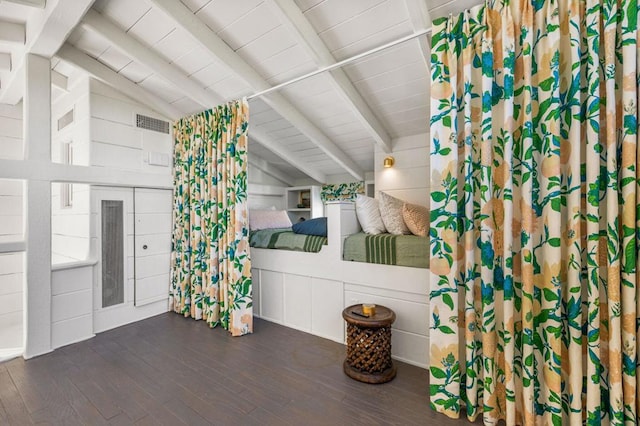 interior space featuring lofted ceiling with beams and dark hardwood / wood-style floors