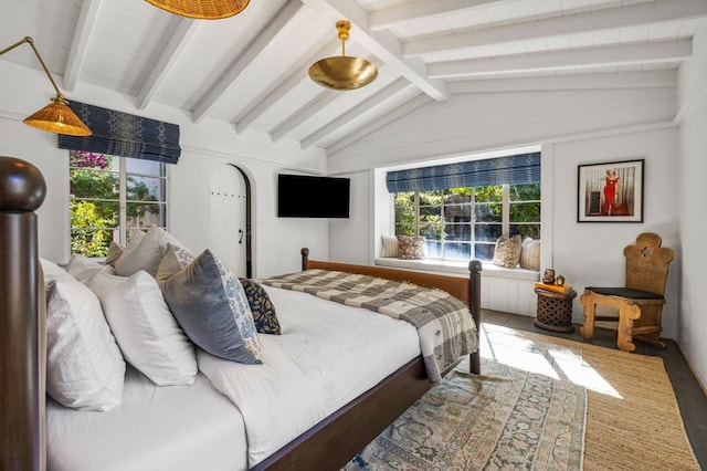 bedroom with vaulted ceiling with beams and hardwood / wood-style floors