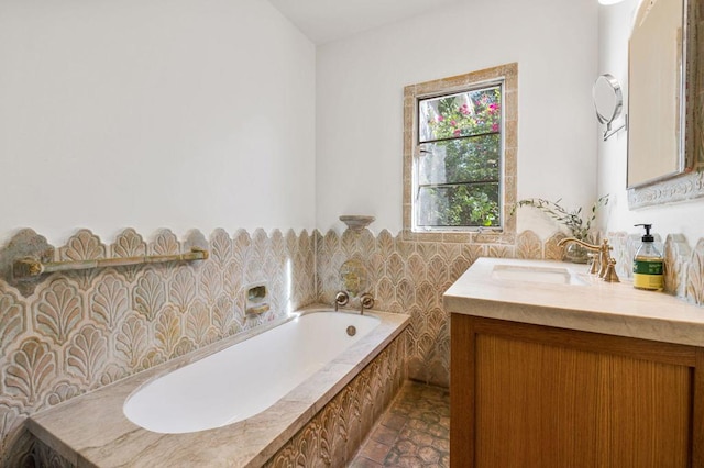 bathroom featuring vanity and tiled tub