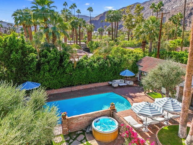 view of pool with a mountain view and a patio