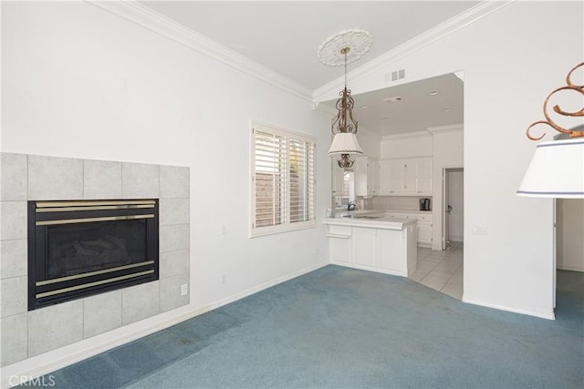 unfurnished living room with a fireplace, light colored carpet, crown molding, and sink