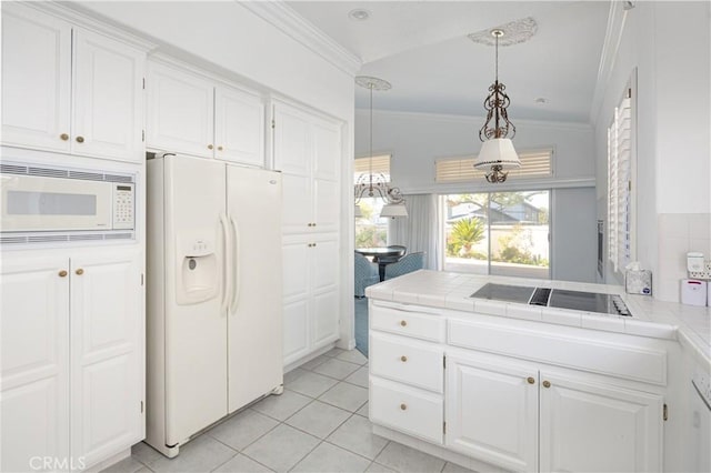 kitchen with tile countertops, white appliances, white cabinets, hanging light fixtures, and vaulted ceiling