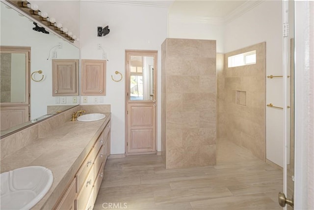 bathroom with tiled shower, hardwood / wood-style flooring, vanity, and ornamental molding