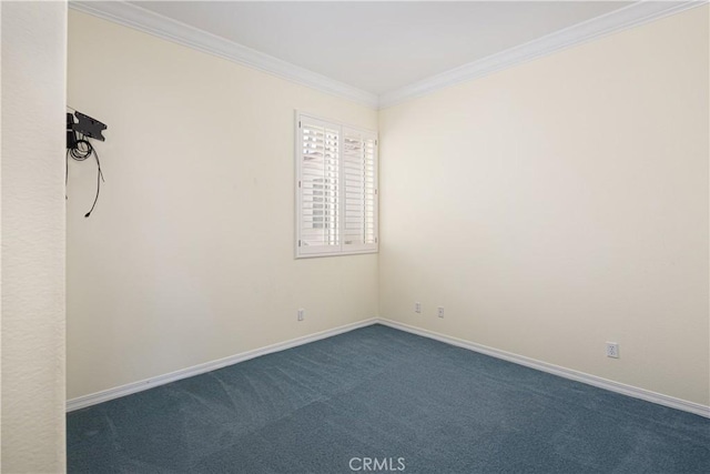 spare room with dark carpet and crown molding