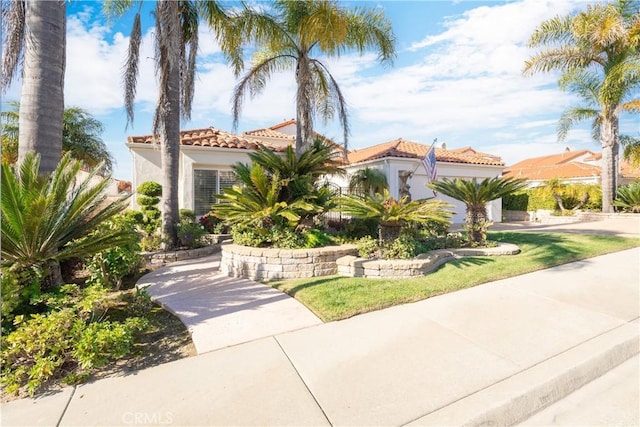 mediterranean / spanish-style home featuring a front lawn